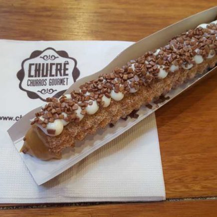 Churros tradicional recheado de doce de leite brasileiro com cobertura de leite ninho e topping de flakes de chocolate ao leite!