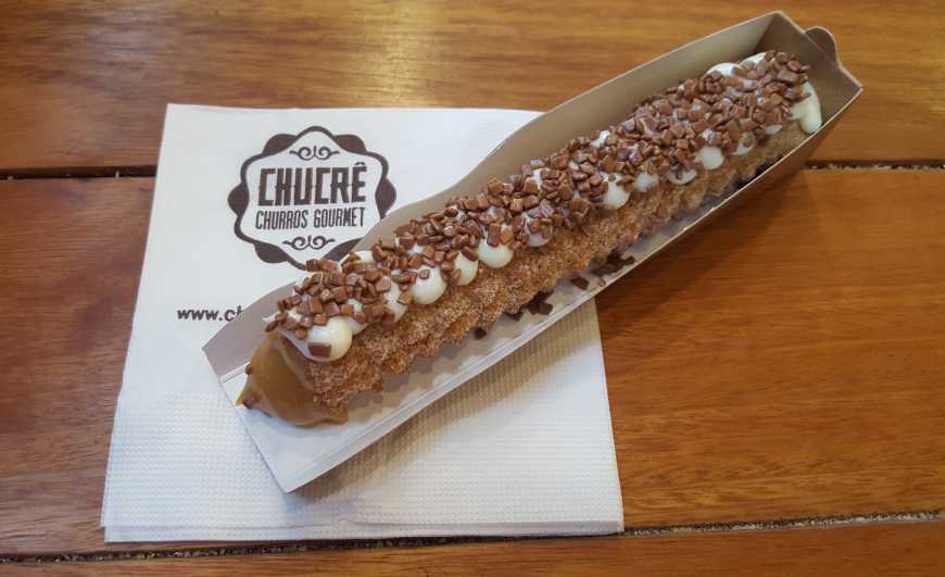 Churros tradicional recheado de doce de leite brasileiro com cobertura de leite ninho e topping de flakes de chocolate ao leite!